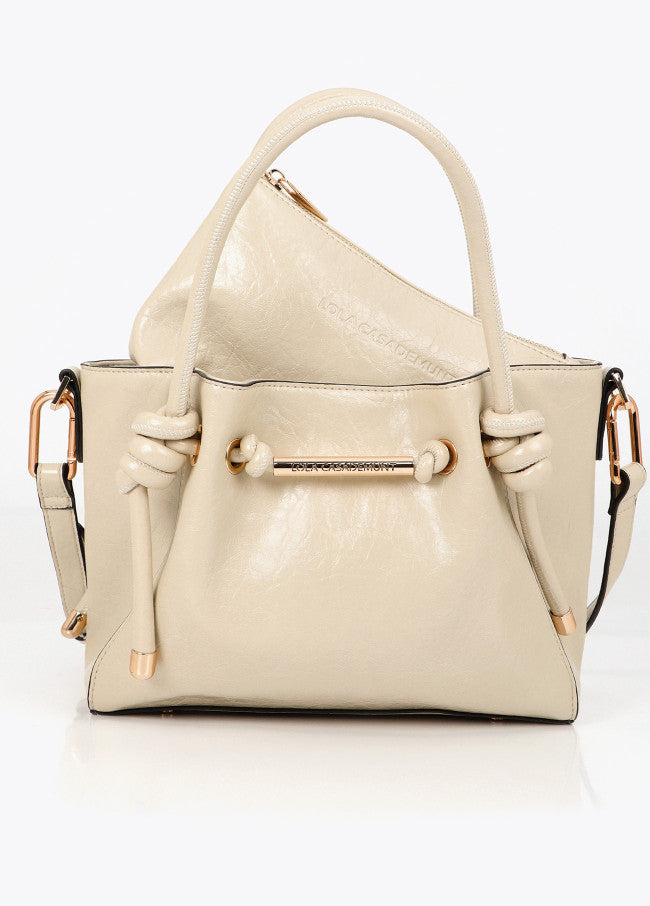 Crossbody bag with metal tube detail with die-cut logo