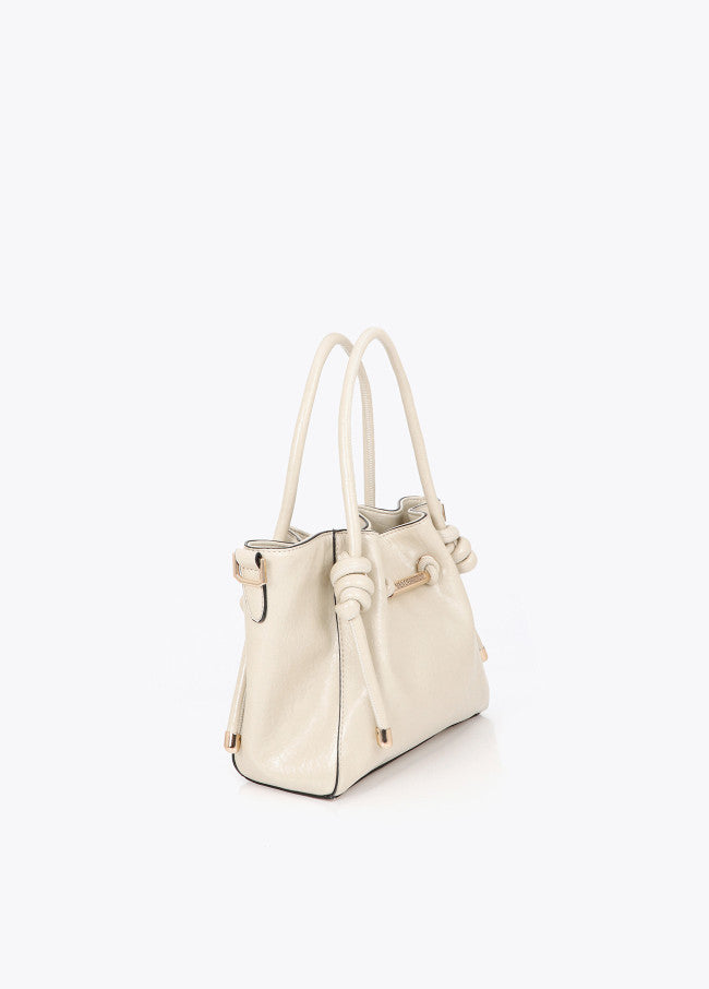 Crossbody bag with metal tube detail with die-cut logo