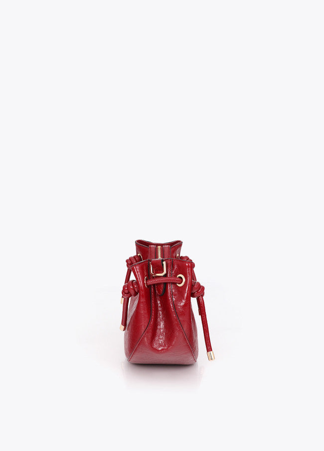 Half-moon shoulder bag with metallic tube detail with die-cut logo