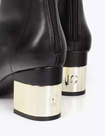 Golden heel boot and rhinestone detail on the sole