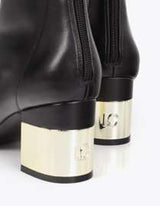 Golden heel boot and rhinestone detail on the sole