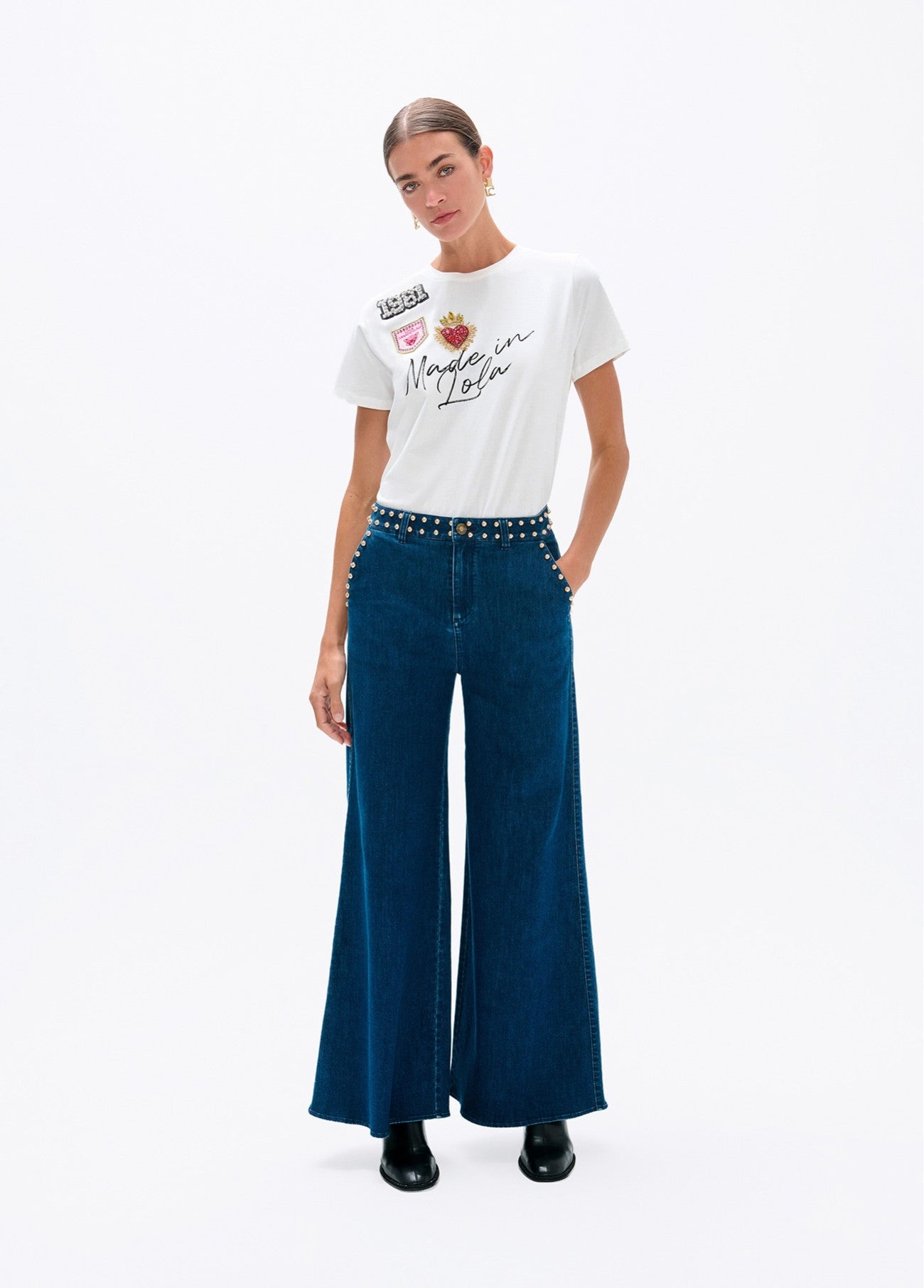 Flared denim with studs on waistband and front pockets