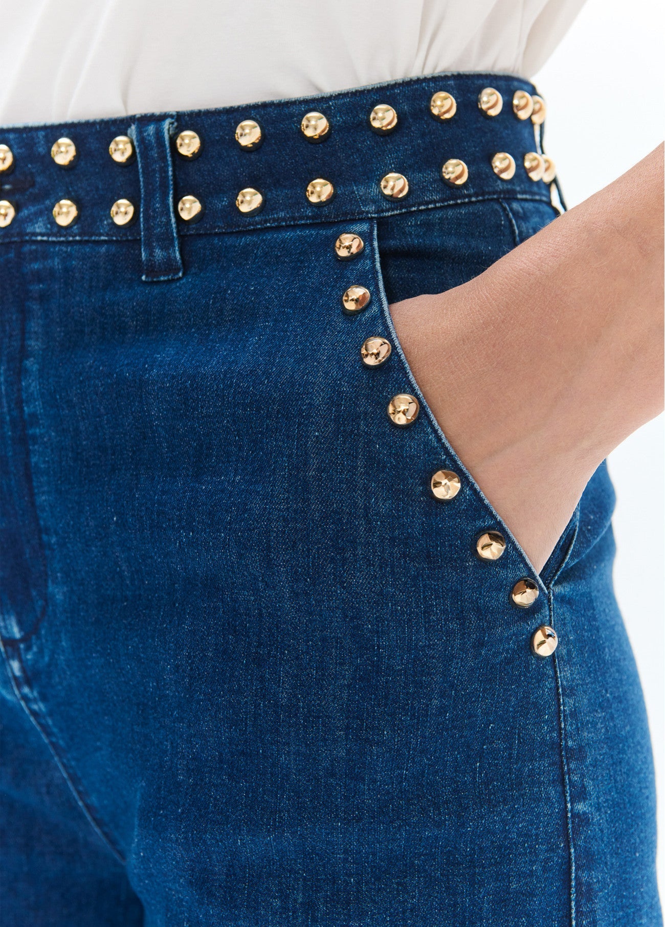 Flared denim with studs on waistband and front pockets