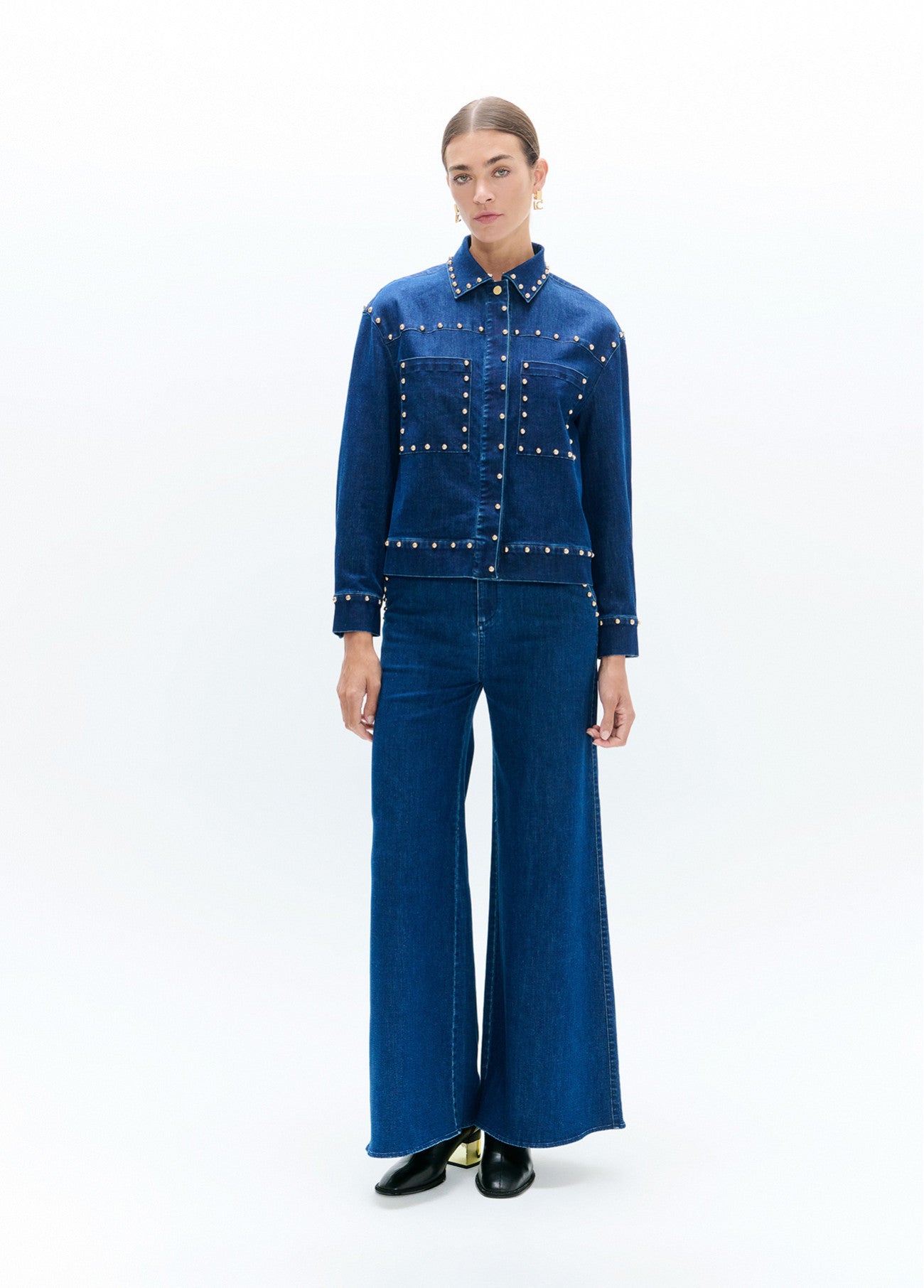 Flared denim with studs on waistband and front pockets