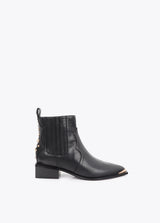 Cowboy-style ankle boots with studs and metal bracelet