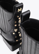 Cowboy-style ankle boots with studs and metal bracelet
