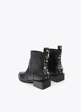 Cowboy-style ankle boots with studs and metal bracelet