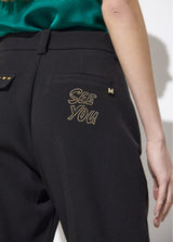 Ankle-length trousers with studded detail on pocket and " see you "