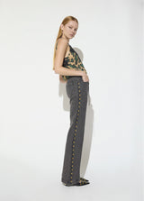 Long straight jeans with studded side detail and belt with custom buckle