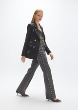 Long straight jeans with studded side detail and belt with custom buckle