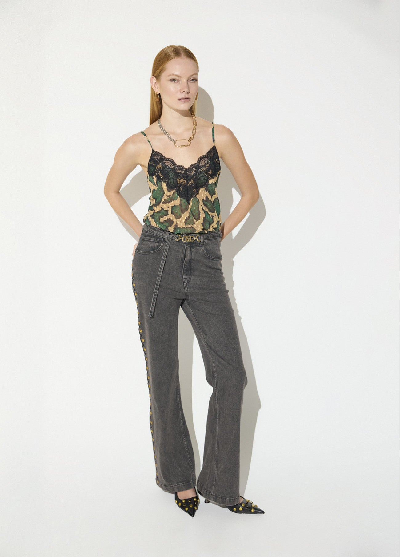 Long straight jeans with studded side detail and belt with custom buckle